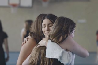 La maman de Morane étreint deux élèves du CO de Leytron, bouleversées par son témoignage