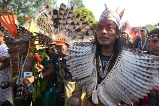 De nombreux indigènes, en tenue traditionnelle et parfois munis de lances, d'arcs et de flèches, ont participé à la manifestation. KEYSTONE/AP/Andre Penner