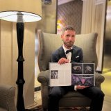 Grégoire Maret présente la double page qui lui est consacrée dans l'album 'Strive for Perfection: The Official Platinum Jubilee Edition'.